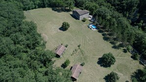 An aerial view of a property with two buildings, a swimming pool, and surrounding forest. - Chalet 'D'alpion' with Shared Pool, Private Terrace and Shared Garden (LES TOURRETTES)