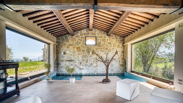 A covered patio with stone walls, a stone floor, and a view of the outdoors. - Villa 'Le Buccole Country House' con vista sulle colline perugine, Wi-Fi e aria condizionata. (Marsciano)