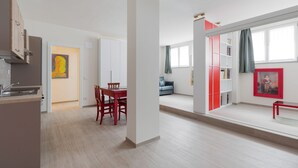 Een modern appartement met keuken, eethoek en zithoek.
