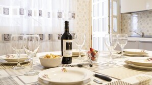 A dining table set with plates, glasses, a bottle of wine, and a bowl of food. - GuestHost - Large and bright apartment that can accommodate up to 5 people with 2 bedrooms and 2 bathrooms, which boasts a beautiful view of the Villa di Sant'Antonio and, in the distance, of the sea from the balcony and window. Located a few steps from  (Monopoli)