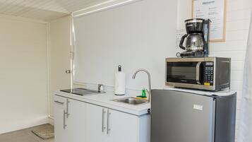 Deluxe Studio | Private kitchen | Full-sized fridge, microwave, toaster, cookware/dishes/utensils