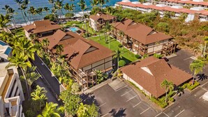 A resort with multiple buildings, a swimming pool, and a view of the ocean. - 🏖️Ocean Front! | Second Floor with AC & Lanai! (Kailua Kona)