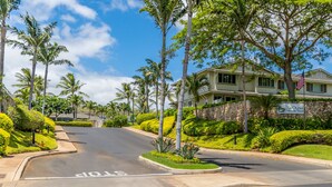A two-story building with a stone facade and a sign reading "Ko Olina Hillside Villas". - Summer Blowout-Avail dates on Sale - Vacation at Ko Olina Hillside Villa 1498-8 (Kapolei)