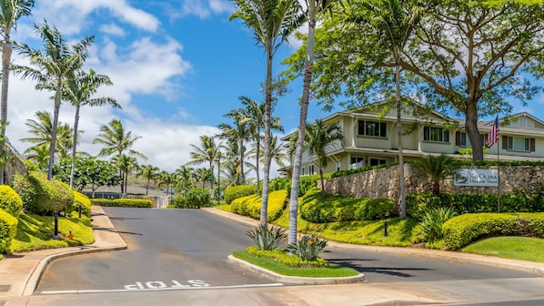 A two-story building with a stone facade and a sign reading "Ko Olina Hillside Villas".