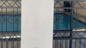 A pool area with a decorative sign that reads "Pool Time" and a palm tree symbol.