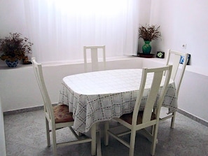 A dining area with a table and four chairs. - Apartment Serene Step From The Sea, Sleeps 5 (Tkon)