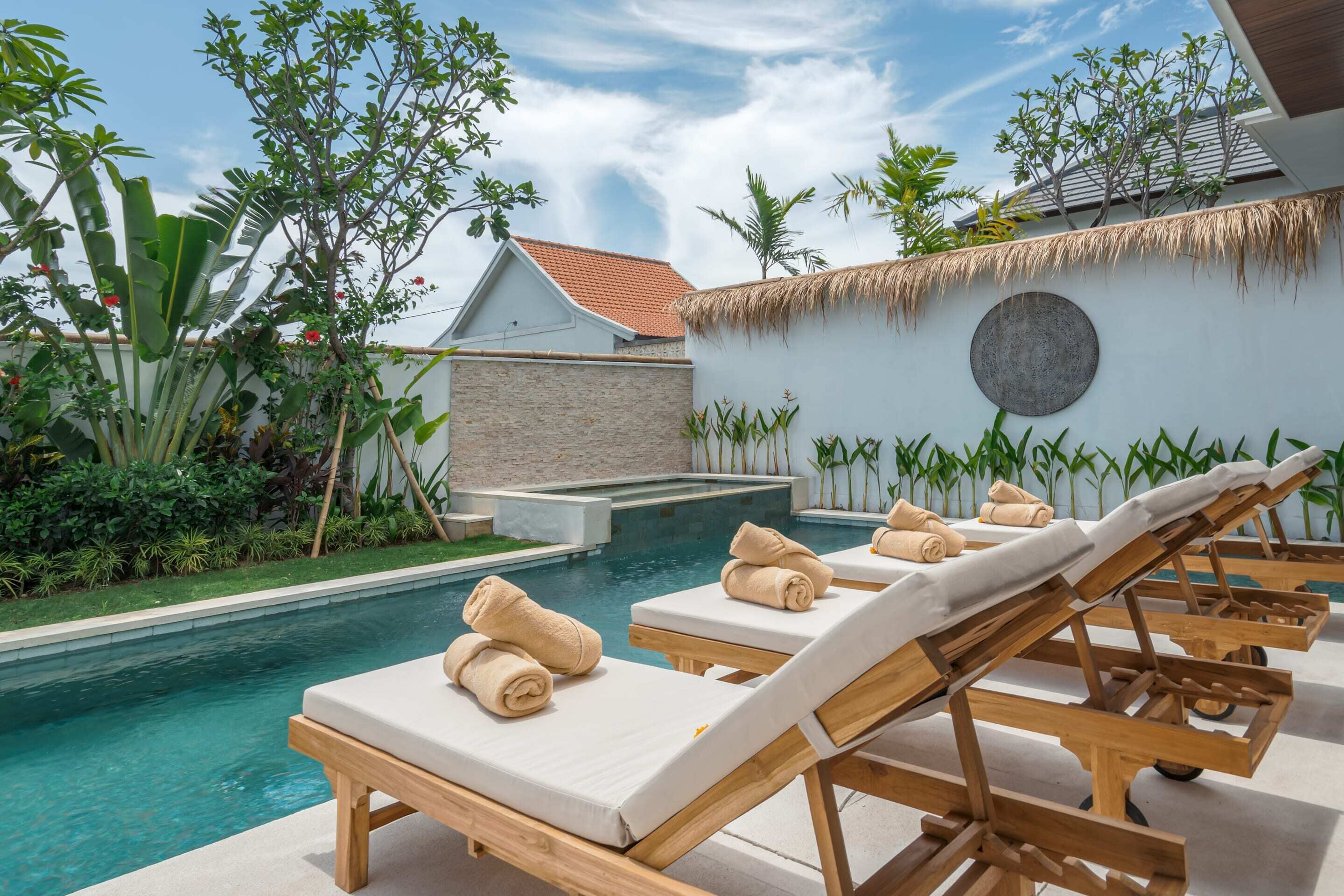 A poolside area with lounge chairs and a small pool.