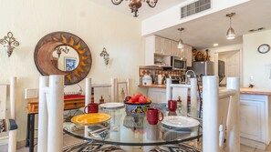 Enjoy meals in this stylish dining area with a glass-top table and comfortable seating.