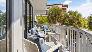 A balcony with outdoor seating, including a sofa and chairs, and a small table. - Beach Rd, 300ft to Beach Access & 500ft to Siesta Key Village, 2bdr (Siesta Key)