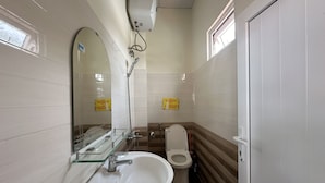 A bathroom with a sink, mirror, toilet, and a showerhead. - SPOT ON 1229 Happy Dream Homestay (Lam Vien - Da Lat)