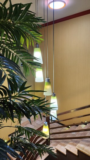 A staircase with wooden railings and a potted plant.