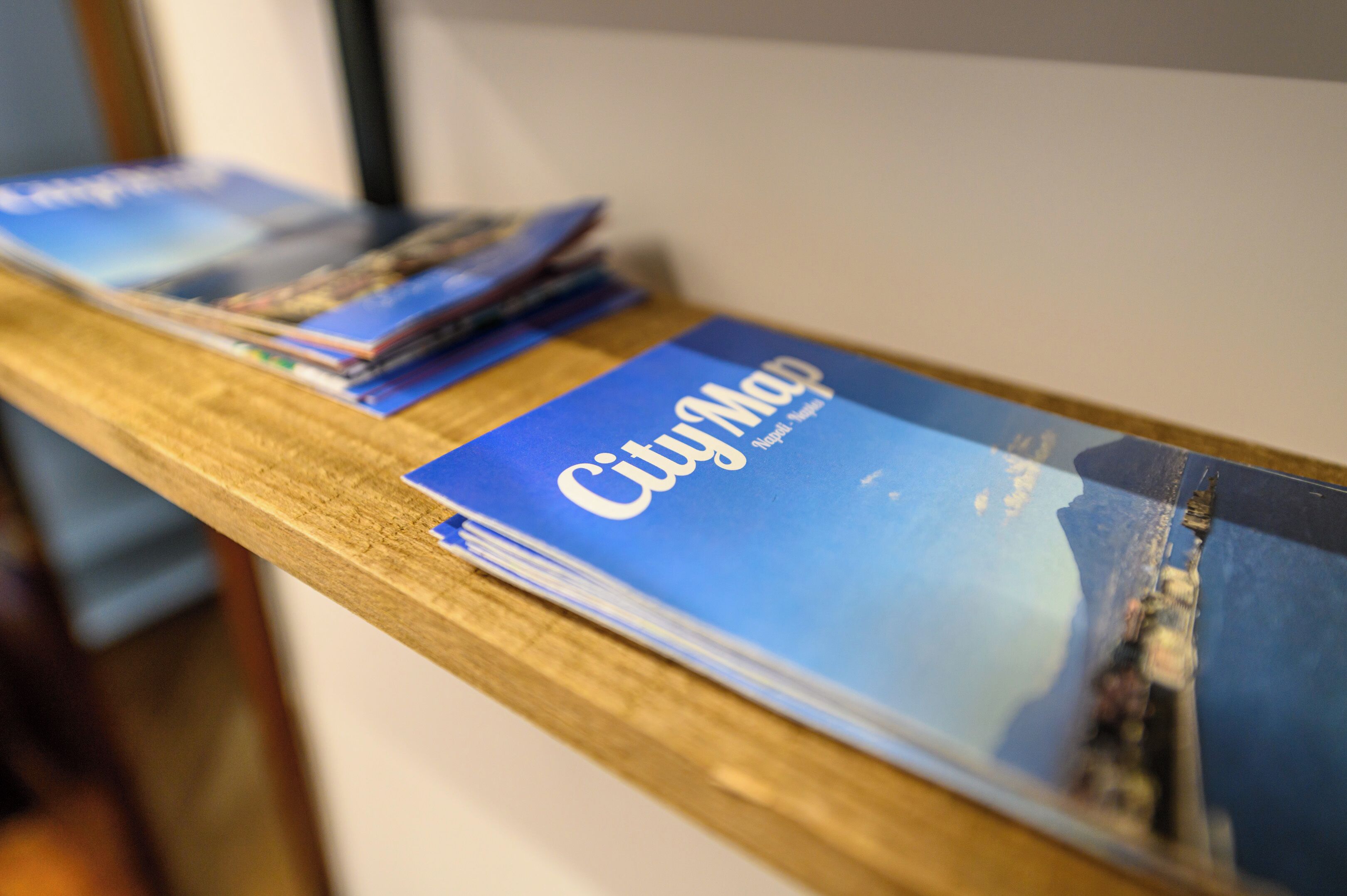 A stack of CityMap brochures on a wooden table.