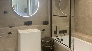 Deluxe tweepersoonskamer | Badkamer | Een douche, een regendouche, een haardroger, handdoeken