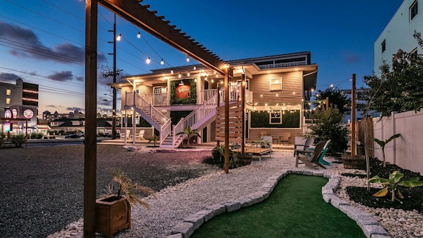 A building with a covered porch, a staircase, and a small artificial lawn. - Hidden Gem in N. OC on the Beach (Ocean City)