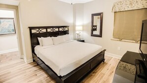 A bedroom with a bed, a ceiling fan, a TV, and a window with a view. - Coastal Comfort Redefined: 3 Bedroom Condo (North Myrtle Beach)