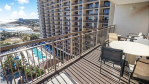 A high-rise hotel with a balcony featuring a pool, outdoor seating, and a view of the beach and ocean. - 3 Bedroom Condo with King and Queen Sized Beds (North Myrtle Beach)