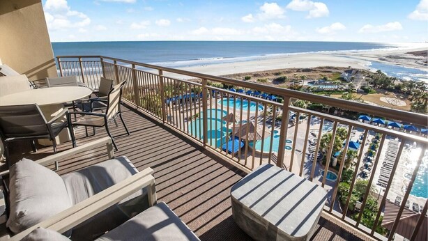 A balcony with a view of the beach and a pool area. - 3 Bedroom Condo with King and Queen Sized Beds (North Myrtle Beach)