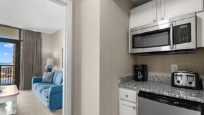 A compact kitchen with a microwave, toaster, and dishwasher. - Relax and Unwind in this Oceanfront 1 Bdrm Condo (North Myrtle Beach)