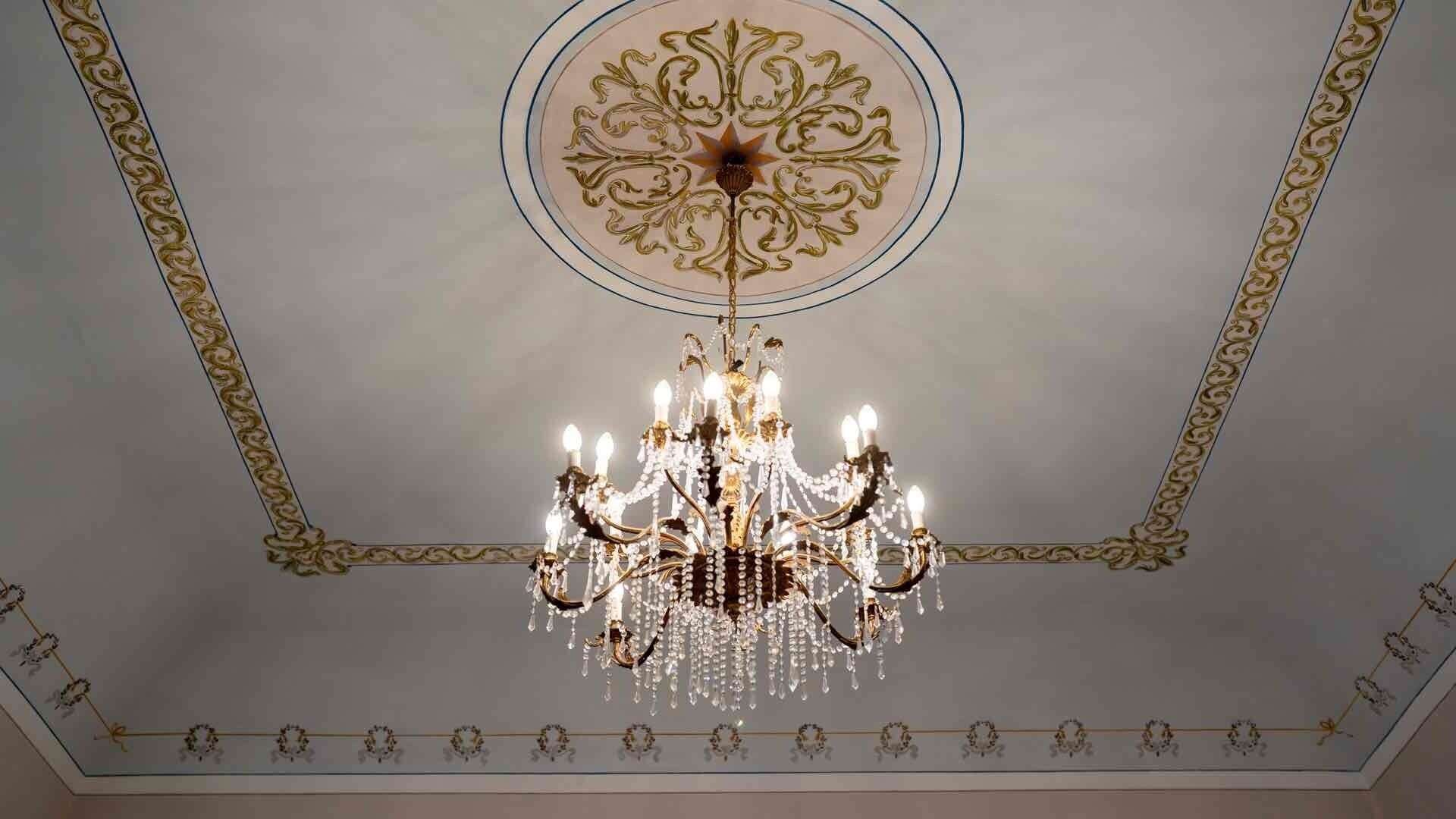 A chandelier with multiple light fixtures and crystal decorations.