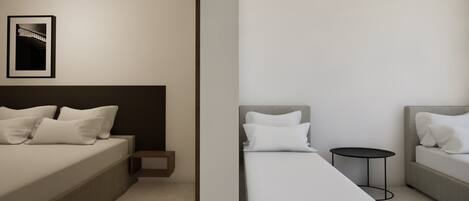 A modern hotel room with a bed, bedside table, and a small round table.