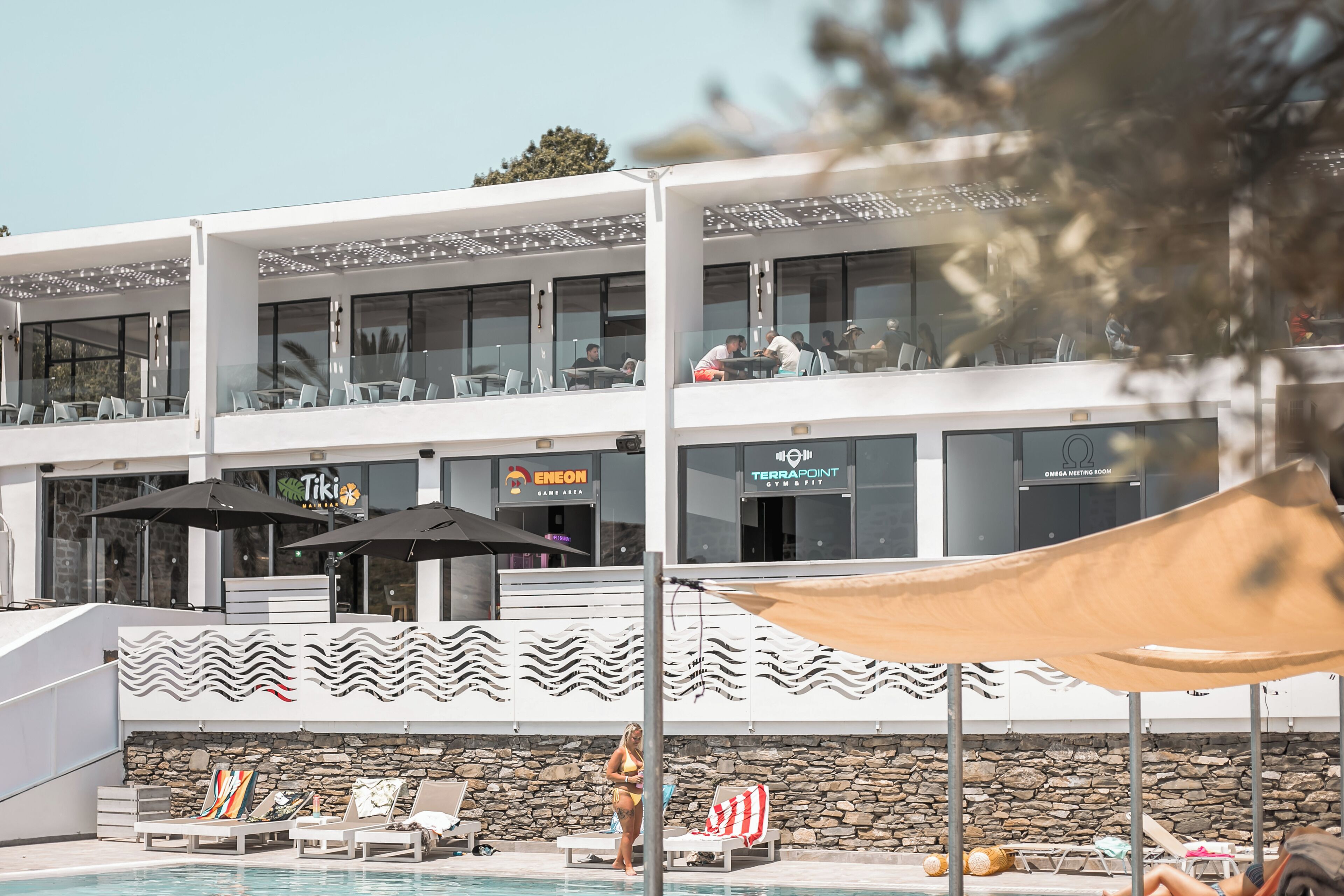 A hotel with a pool area, multiple dining options, and a meeting room.