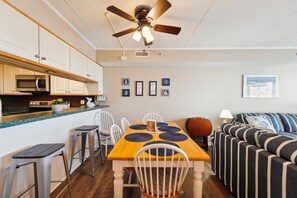 A compact living space with a kitchenette, dining area, and seating area.