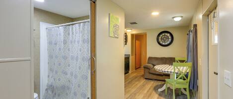 A compact living space with a bathroom, a dining area, and a living room.