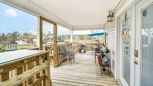 A covered deck with a pool table, outdoor seating, and a grill area. - Waterfront Bay St Louis Home w/ Private Dock! (Bay St Louis)