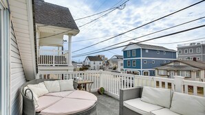 A balcony with wicker furniture and a small table. - Wildwood Retreat w/ 2 Balconies: 5 Blocks to Beach (Wildwood)