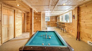 A pool table in a wooden room with a bar area and chairs. - Bigfork Cabin on Long Lake By Trails & Restaurant! (Bigfork)