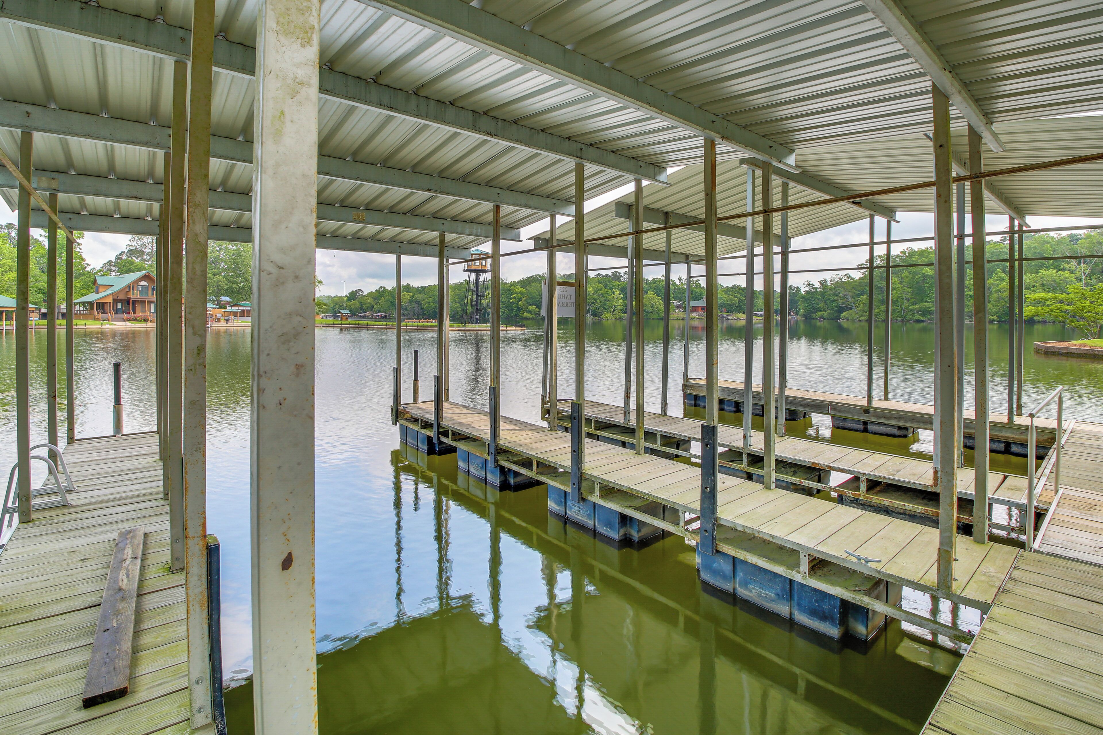A covered dock area with multiple wooden benches and a metal railing.