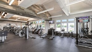 A gym with treadmills, elliptical machines, and weight equipment.
