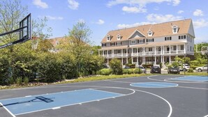 A basketball court with a building in the background.