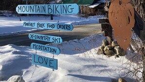 A wooden sign with multiple directions for activities like mountain biking, organic farming, and meditation. - Streeter Mountain Farm (Rumney)
