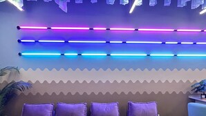 A modern room with a bed, purple pillows, and a ceiling with blue and purple LED lights. - Urban Designer Collection Lebuh Melaka (George Town)