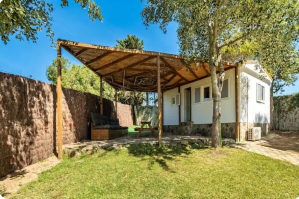 Guests can relax under the pergola in this serene outdoor space.