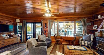 1-acre lakefront log cabin with dock, 50 ft water frontage, hot tub, & deck