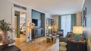 A modern living room with a sofa, a coffee table, and a dining area with a table and chairs. - Superb new flat Notre Dame de Paris (Paris)