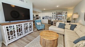 A living room with a TV, sofa, and coffee table.