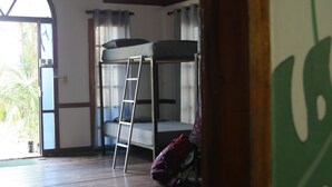 A room with a bunk bed, a ladder, a window with curtains, and a door leading outside. - Hotel Mandacaru Puerto Viejo (Cahuita)