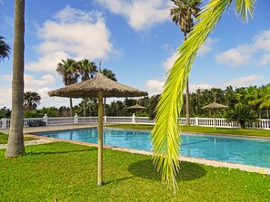 Seasonal outdoor pool, open 9:00 AM to 10:00 PM, pool umbrellas