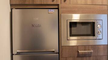 Family Apartment, 3 Bedrooms | Private kitchen | Full-sized fridge, microwave, oven, stovetop