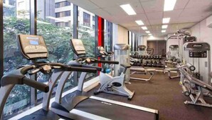 A gym with treadmills, stationary bikes, and weight machines. - Discover Urban:1BR|Pool|Gym|Sauna|Convenient (Brisbane City)