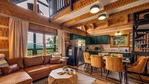 A cozy cabin-style interior with a living area, dining space, and kitchen.