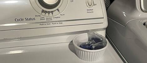 A washing machine with a dial for fabric selection and cycle status.