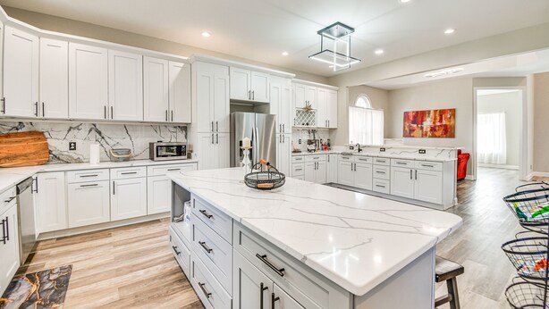 A spacious kitchen with white cabinetry, a large marble island, and modern appliances. - Spacious Hampton Vacation Home Near Beaches! (Hampton)