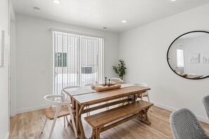 Enjoy meals in this dining area with a wooden table, benches, and comfortable chairs.