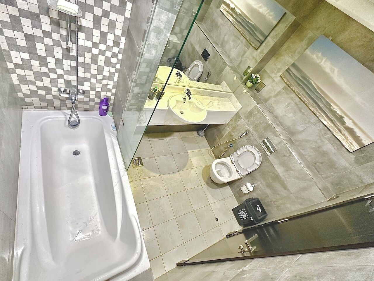 A bathroom with a bathtub, toilet, and sink.