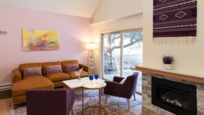 A living room with a sofa set, a coffee table, and a fireplace.