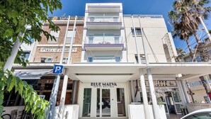 A building with a sign for 'Blue Malva Hostel Boutique' and a visible parking sign. - Blue Malva (Valencia)